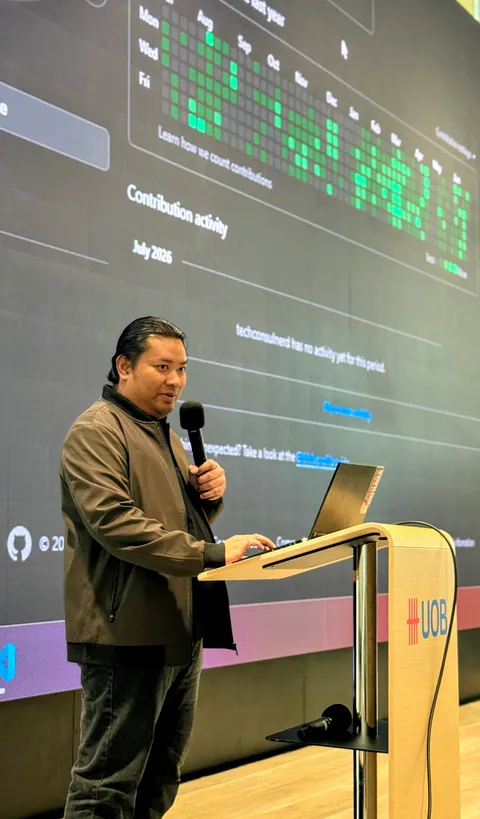 Hafiz Zainudin in a professional speaking engagement at an AI governance or technology conference, addressing an audience from stage